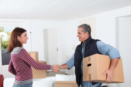 Professional man and van loading furniture for transport in Stanmore