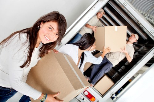 Worker moving stored items carefully in a well-maintained storage aisle